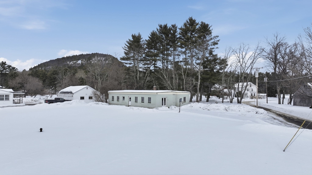 109 Royalston Road Orange, MA 01364 - Photo 3 of 27 a white house that has tree in front of it
