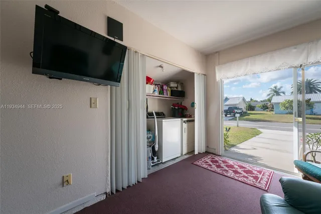 a view of a living room and a flat screen tv