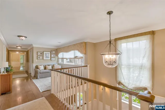 a spacious bedroom with a bed and large windows