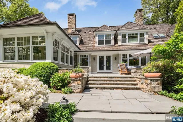 a view of backyard with outdoor seating barbeque oven and trees