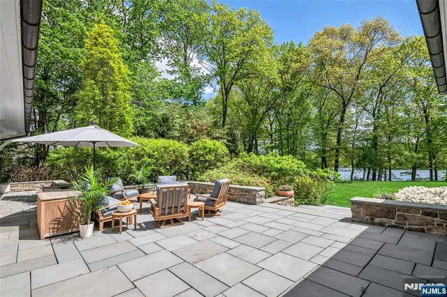 a view of a patio with couches table and chairs and potted plants