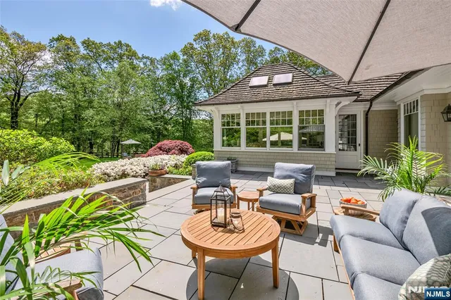a view of backyard with outdoor seating and trees