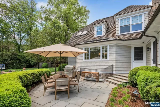a living room with patio furniture and a large window