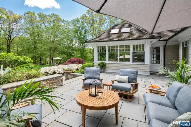 a front view of a house with a garden and plants