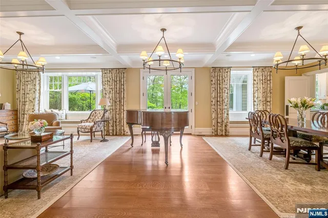 a living room with furniture a chandelier and a fireplace