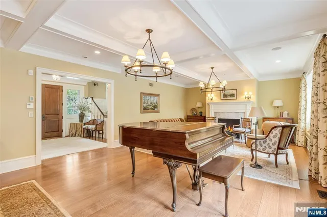 a living room with furniture and a large window with garden view