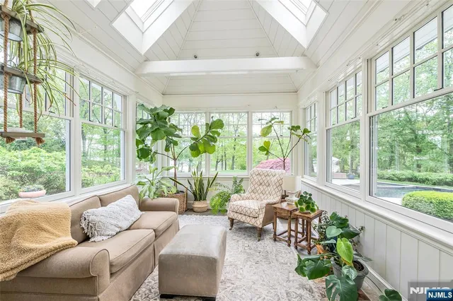 a dining room with furniture window and wooden floor