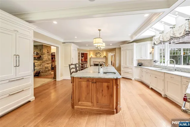 a kitchen with a sink a stove and cabinets