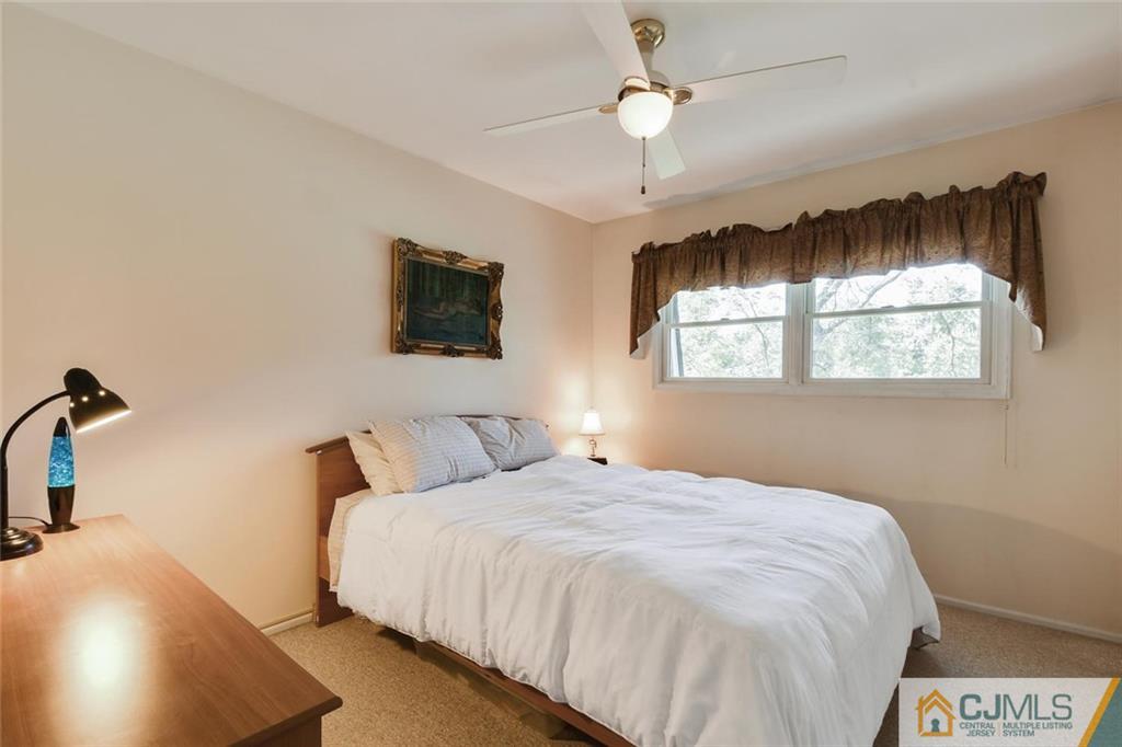 124 Fairfield Road Princeton, NJ 08540 - Photo 17 of 24 a bedroom with a bed and a chandelier