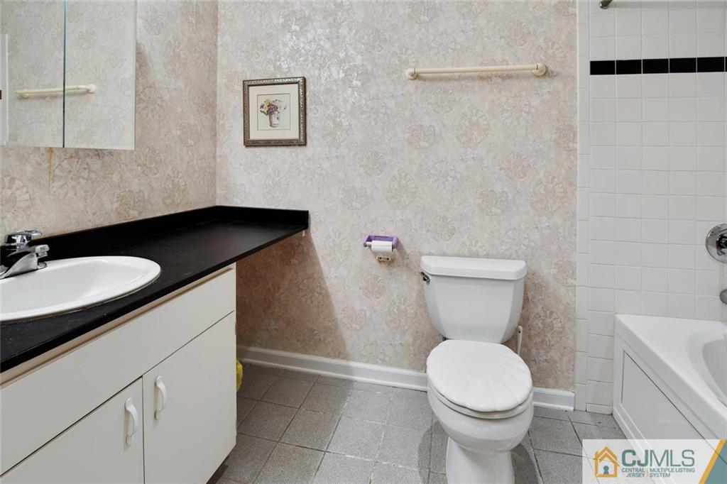 124 Fairfield Road Princeton, NJ 08540 - Photo 20 of 24 a bathroom with a granite countertop toilet sink and mirror
