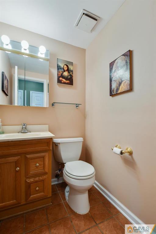 124 Fairfield Road Princeton, NJ 08540 - Photo 21 of 24 a bathroom with a granite countertop toilet a sink and mirror