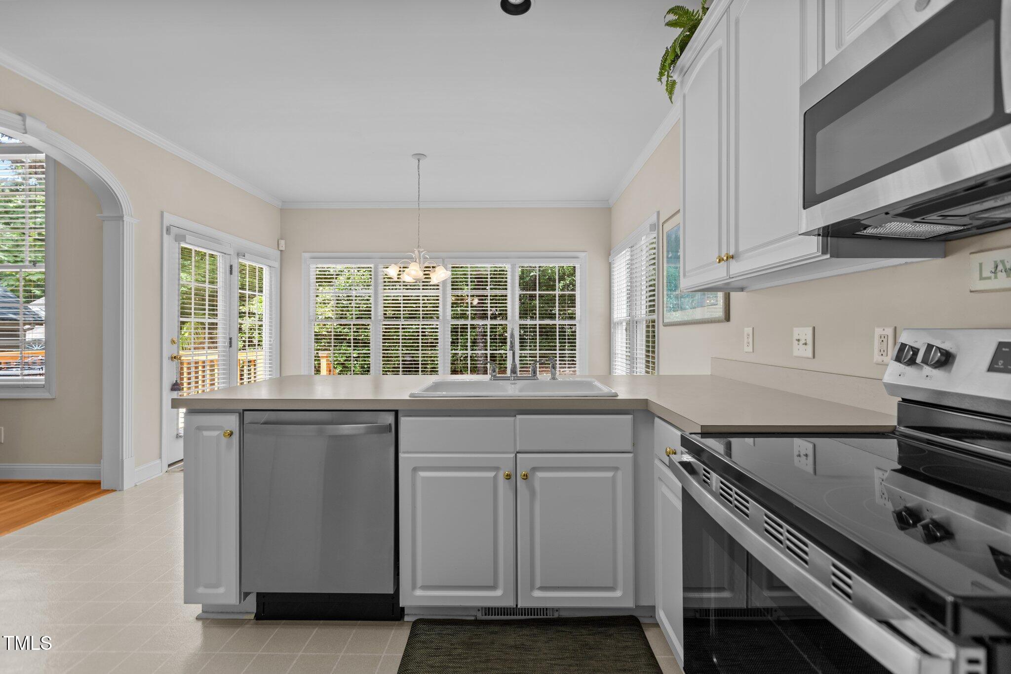 1224 Wedgeland Drive Raleigh, NC 27615 - Photo 15 of 36 a kitchen that has a sink and a stove