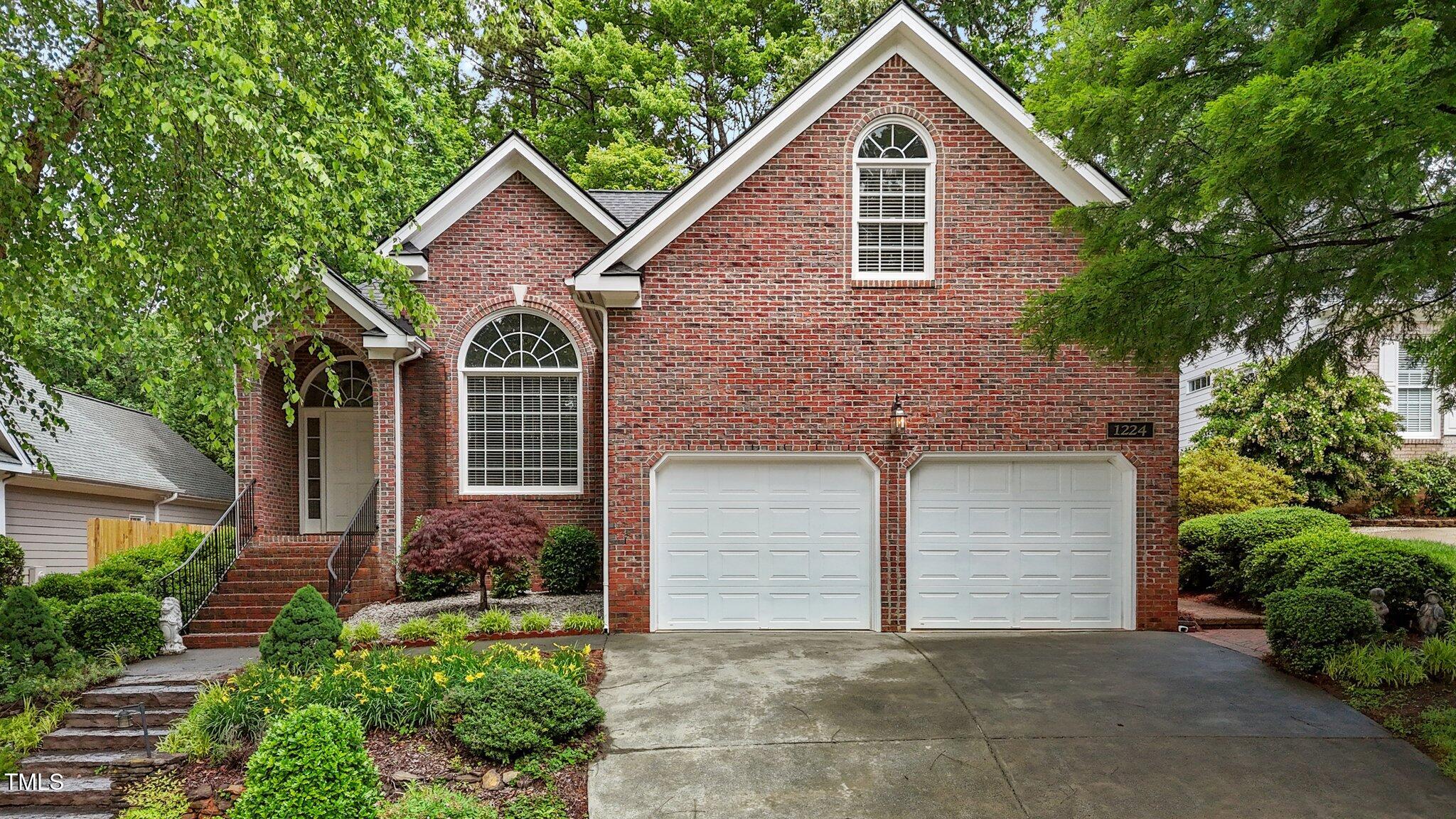 1224 Wedgeland Drive Raleigh, NC 27615 - Photo 2 of 36 a front view of a house with a yard and garage