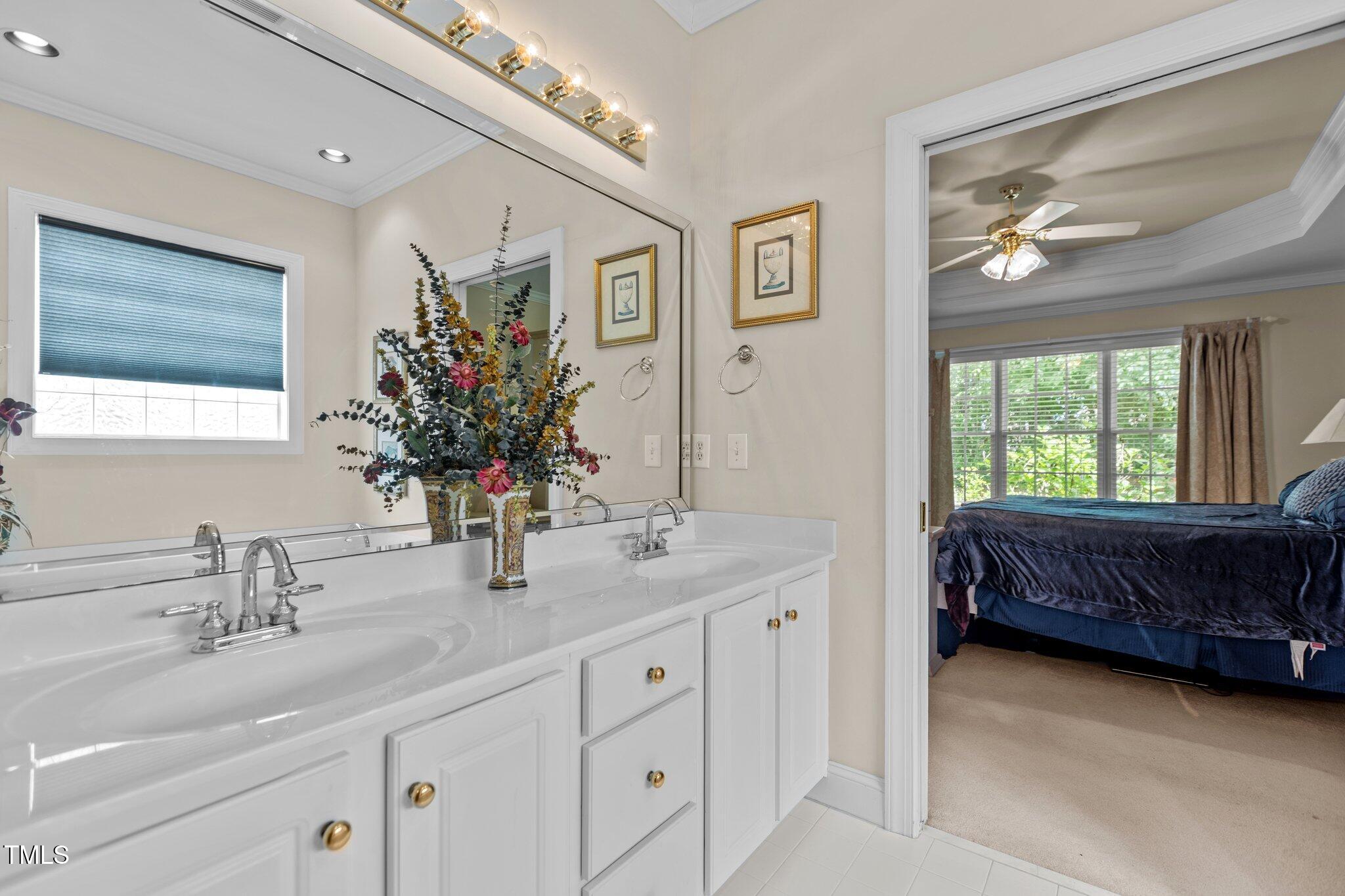 1224 Wedgeland Drive Raleigh, NC 27615 - Photo 23 of 36 a en suite bathroom with double vanity and a mirror