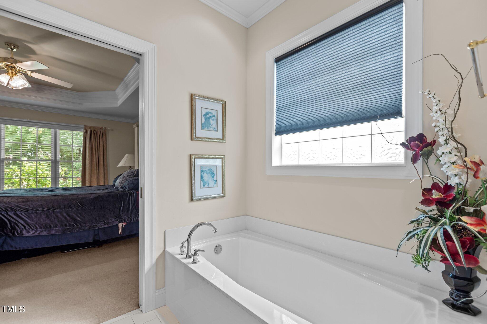 1224 Wedgeland Drive Raleigh, NC 27615 - Photo 24 of 36 a bath room with a bathtub and a potted plant