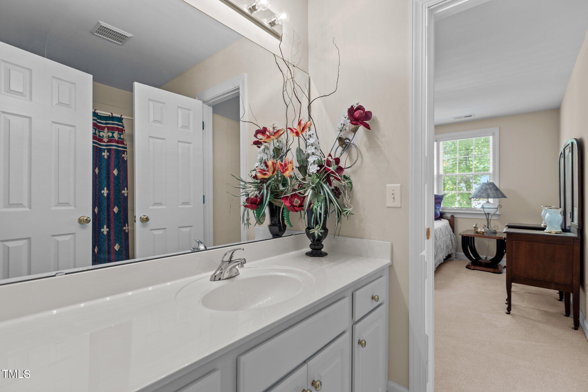 1224 Wedgeland Drive Raleigh, NC 27615 - Photo 26 of 36 a bathroom with a sink and a mirror