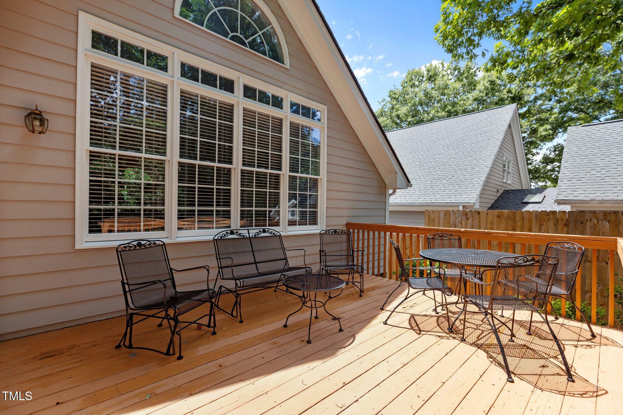 1224 Wedgeland Drive Raleigh, NC 27615 - Photo 30 of 36 a roof deck with table and chairs and wooden floor