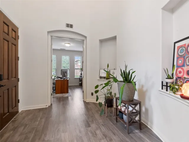a kitchen with stainless steel appliances granite countertop white cabinets and refrigerator