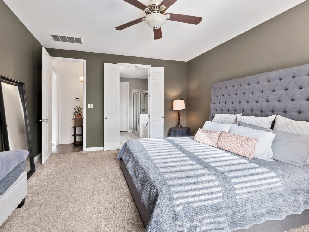 1101 Feather Reed Drive Leander, TX 78641 - Photo 16 of 40 a bedroom with bed and a chandelier