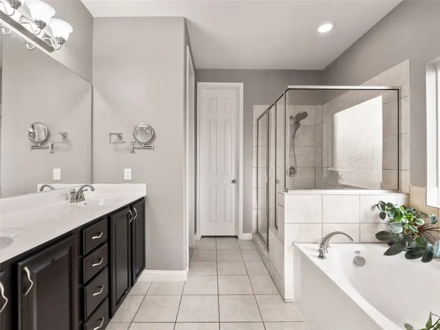 a bedroom with bed and a chandelier