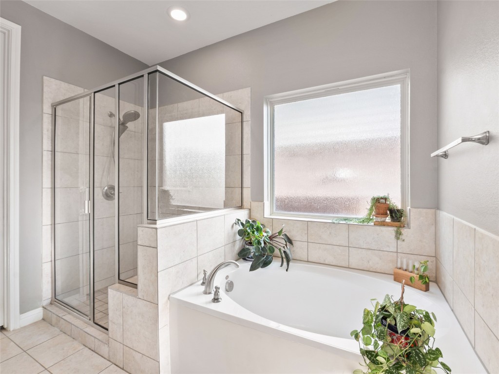 1101 Feather Reed Drive Leander, TX 78641 - Photo 18 of 40 a bath room with a bathtub and a shower