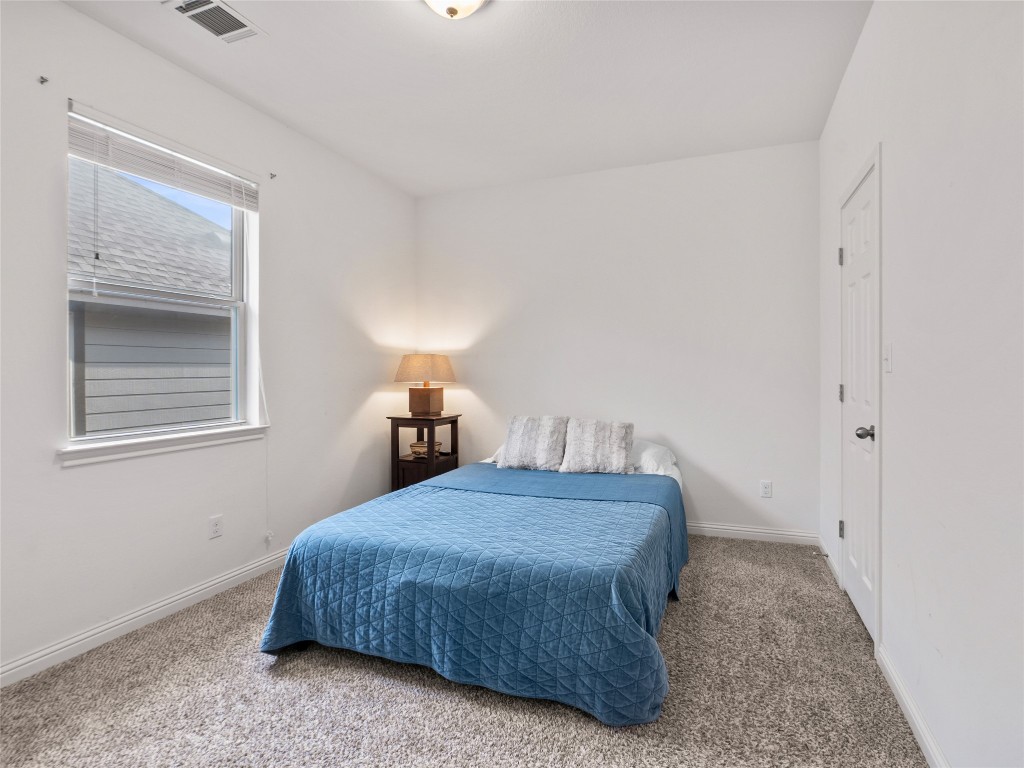 1101 Feather Reed Drive Leander, TX 78641 - Photo 25 of 40 a bedroom with a bed and flowerpot