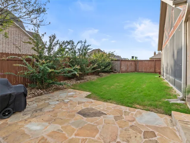 a backyard of a house with outdoor seating