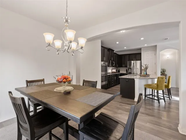 a kitchen with stainless steel appliances granite countertop kitchen island wooden cabinets a refrigerator and stove