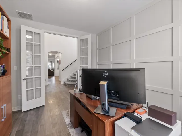 a view of a dining room and a kitchen with a table chairs