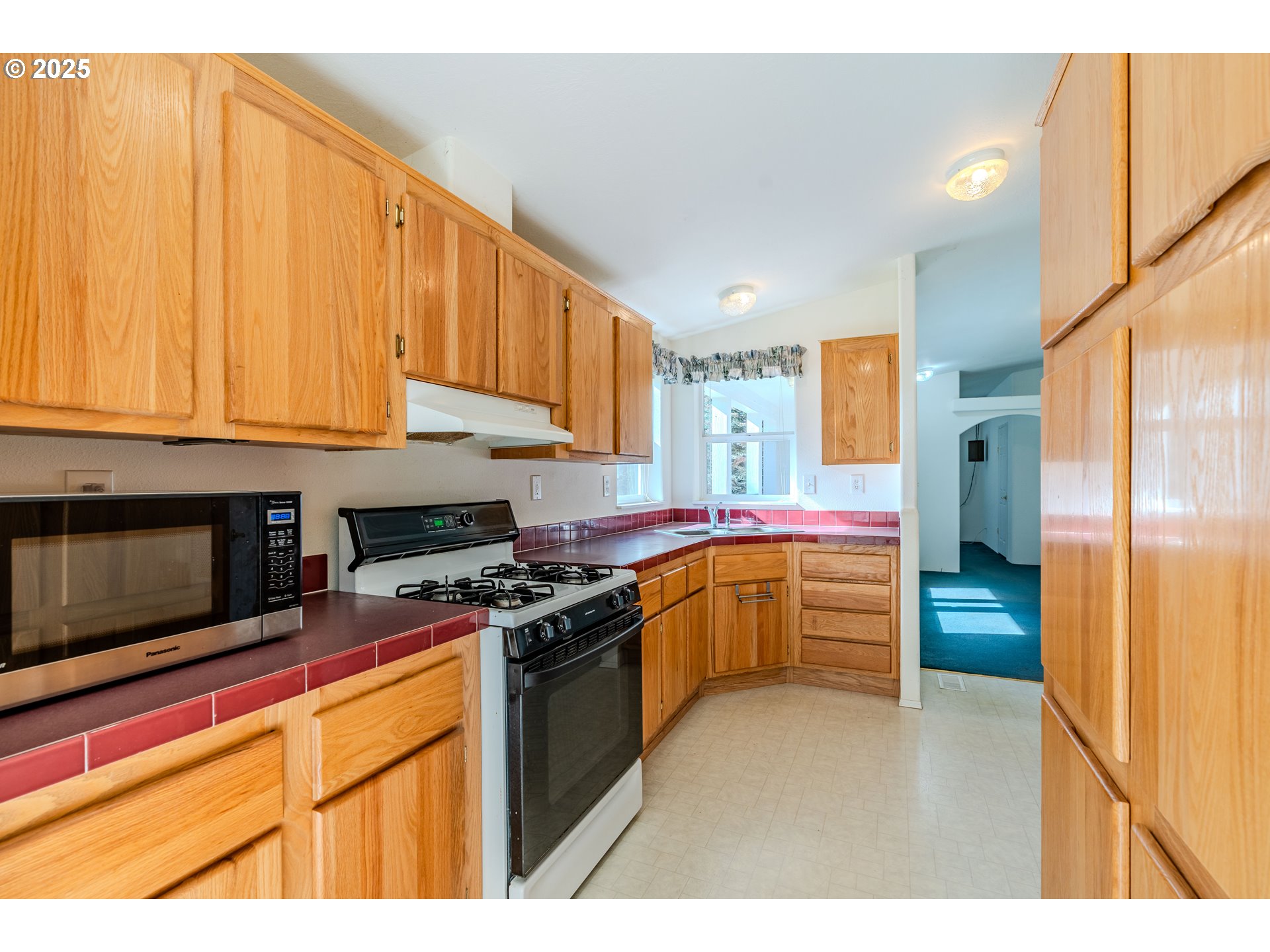 41300 Southeast Louden Road Corbett, OR 97019 - Photo 13 of 48 a kitchen with stainless steel appliances granite countertop a stove a sink and a microwave