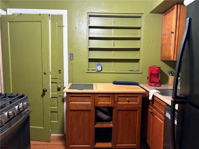 a utility room with a stove top oven and cabinets