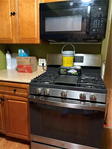 a stove top oven sitting inside of a kitchen