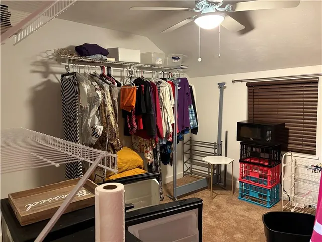 a view of walk in closet with clothes