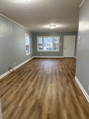 a view of an empty room and a window