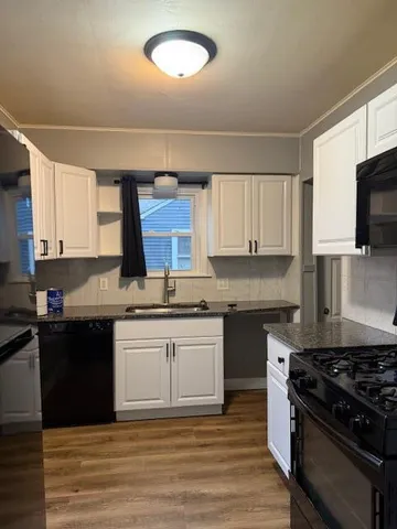 a kitchen with stainless steel appliances granite countertop a stove and a sink