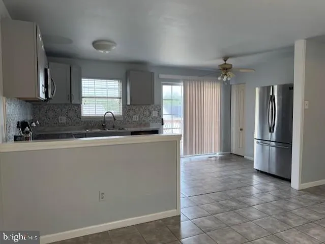 a kitchen with stainless steel appliances a refrigerator and a sink