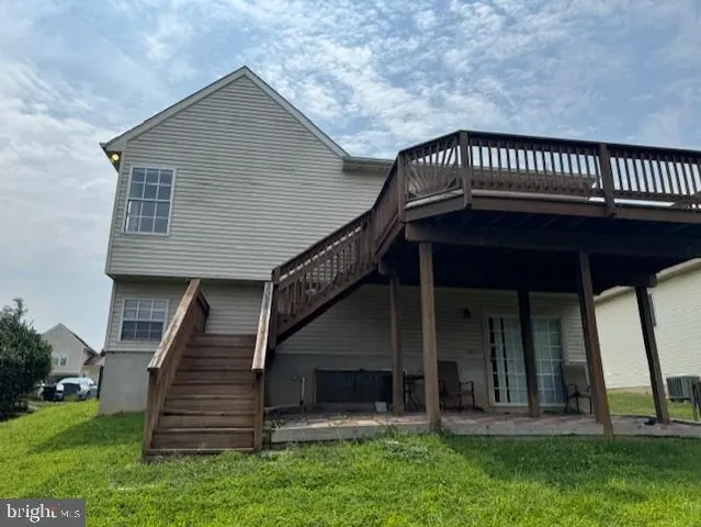 a view of a house with brick walls and a small yard