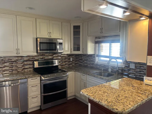 a kitchen with a sink and a stove