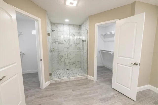 a bathroom with a shower and a glass door