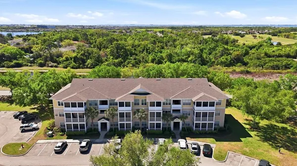an aerial view of a house with swimming pool and green space