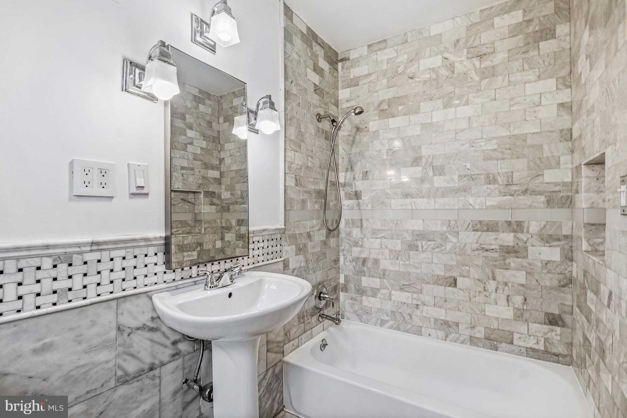 1822 15th Street Northwest, Unit 303 Washington, DC 20009 - Photo 15 of 22 a bathroom with a sink a toilet and shower