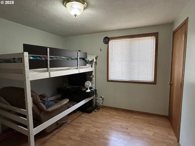 a view of a livingroom with wooden floor and a window