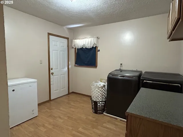 a kitchen with a refrigerator and a stove top oven