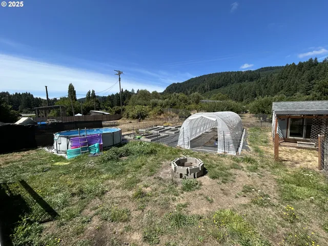 a backyard of a house with table and chairs