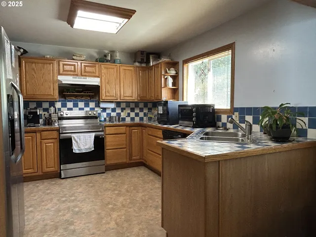 a kitchen with a sink stove and microwave