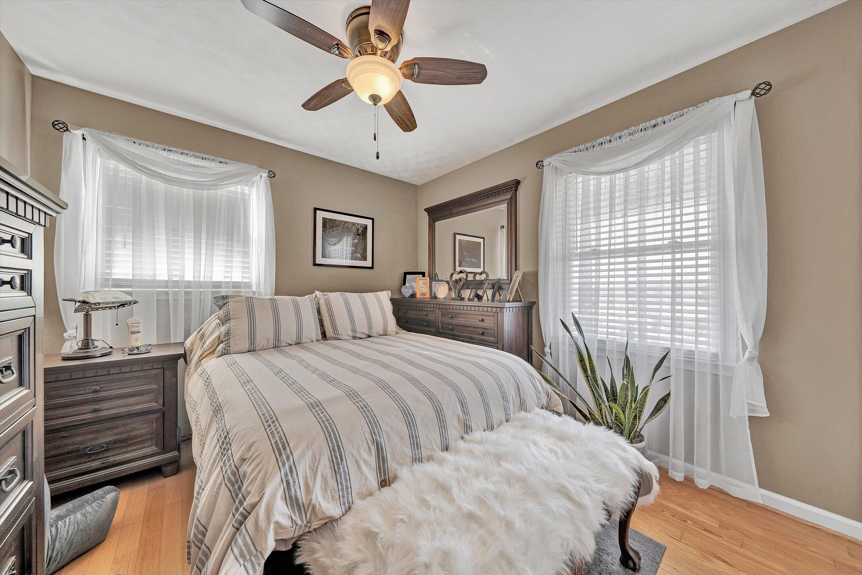 1160 Sandy Level Road Goodview, VA 24095 - Photo 12 of 47 a spacious bedroom with a large bed and a chandelier