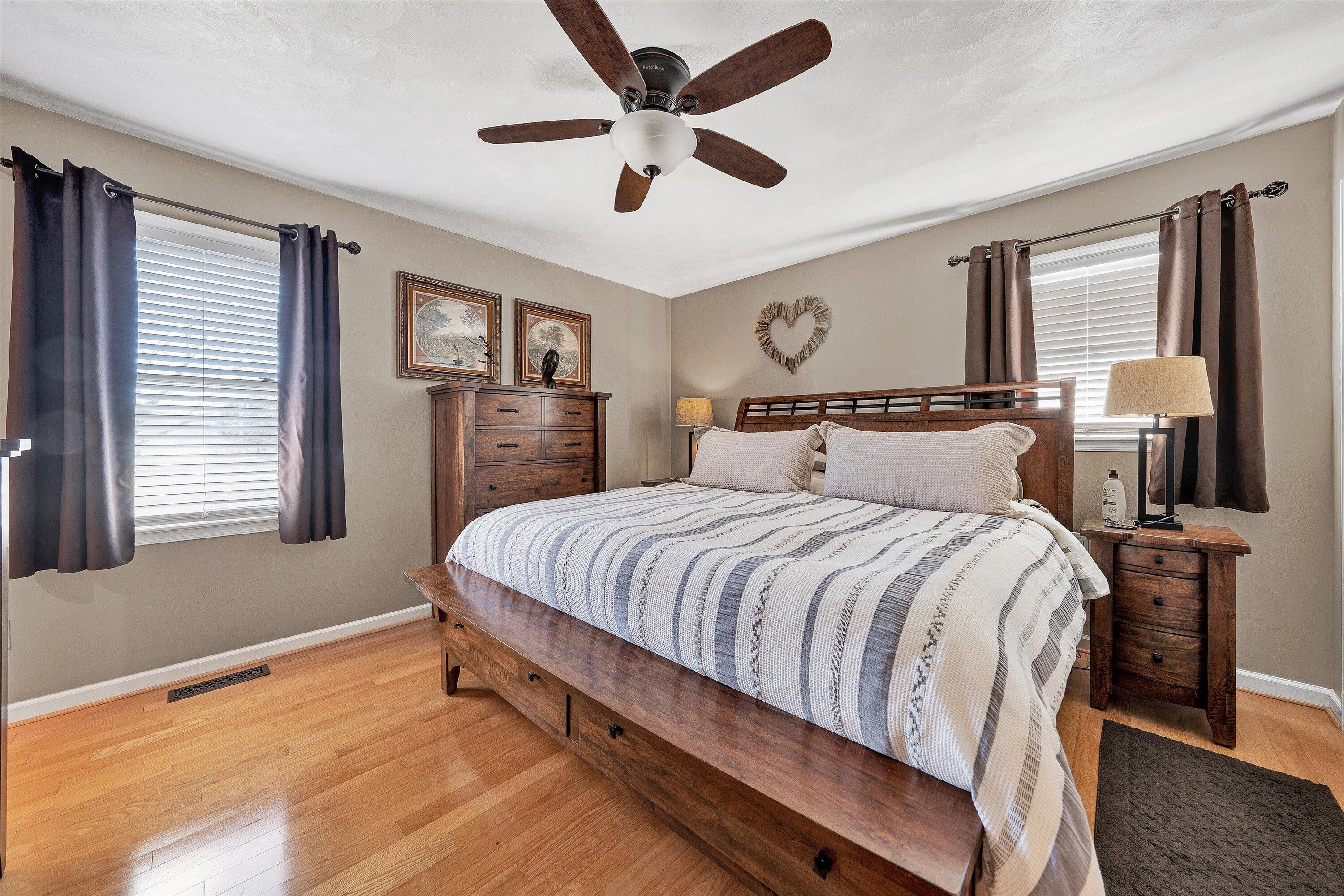 1160 Sandy Level Road Goodview, VA 24095 - Photo 16 of 47 a spacious bedroom with a large bed and two windows