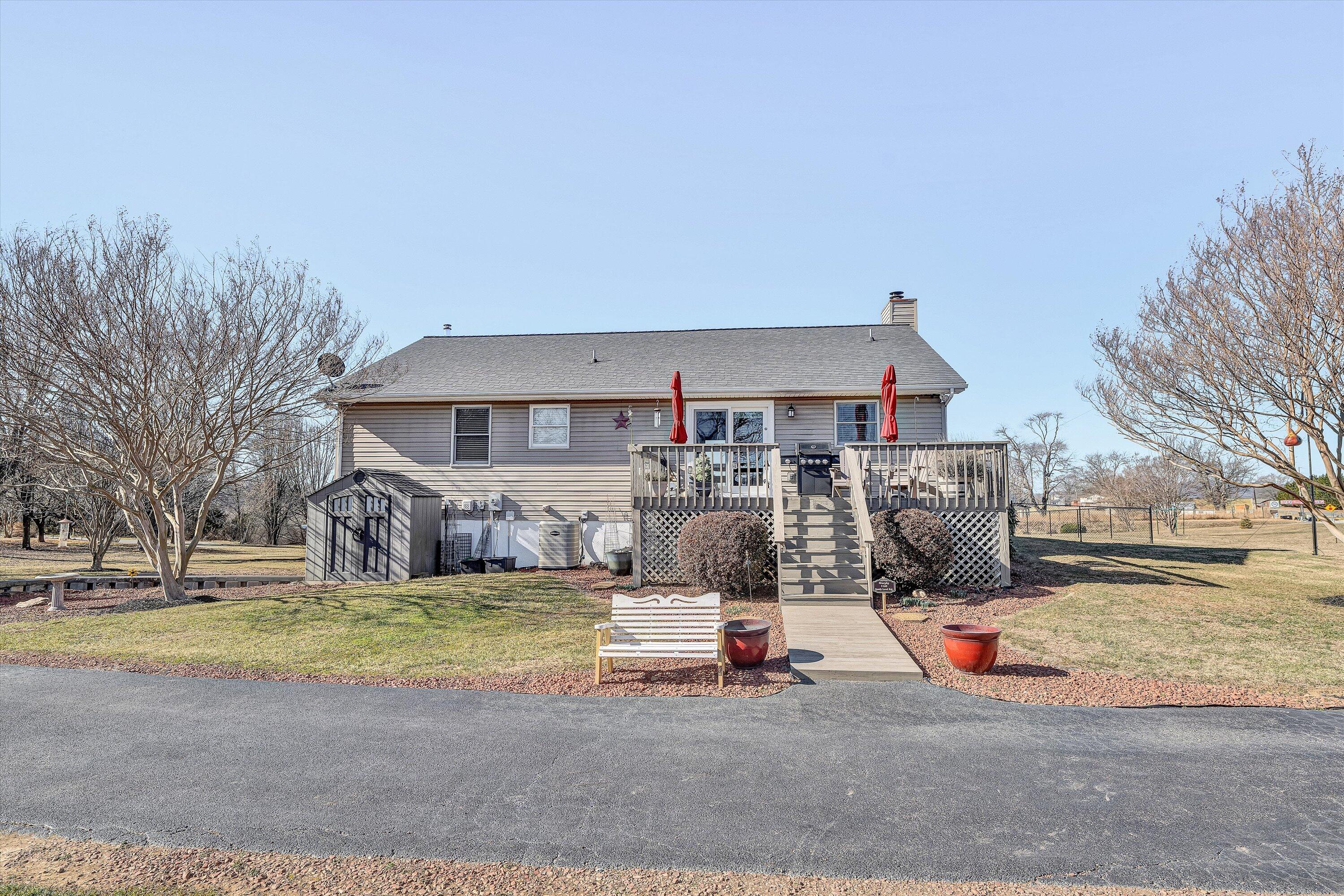 1160 Sandy Level Road Goodview, VA 24095 - Photo 30 of 47 a view of a house with a big yard and large trees