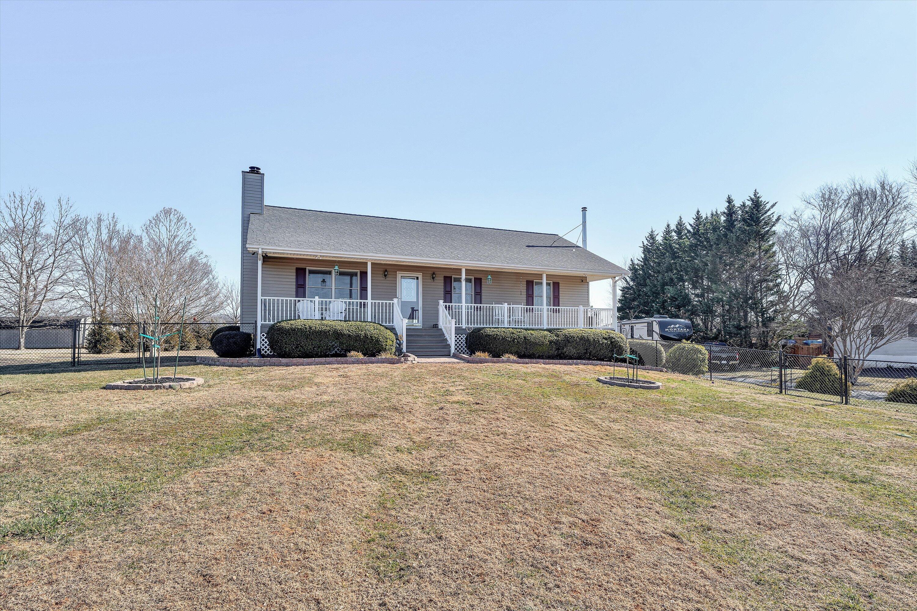 1160 Sandy Level Road Goodview, VA 24095 - Photo 47 of 47 a front view of a house with a yard and garage