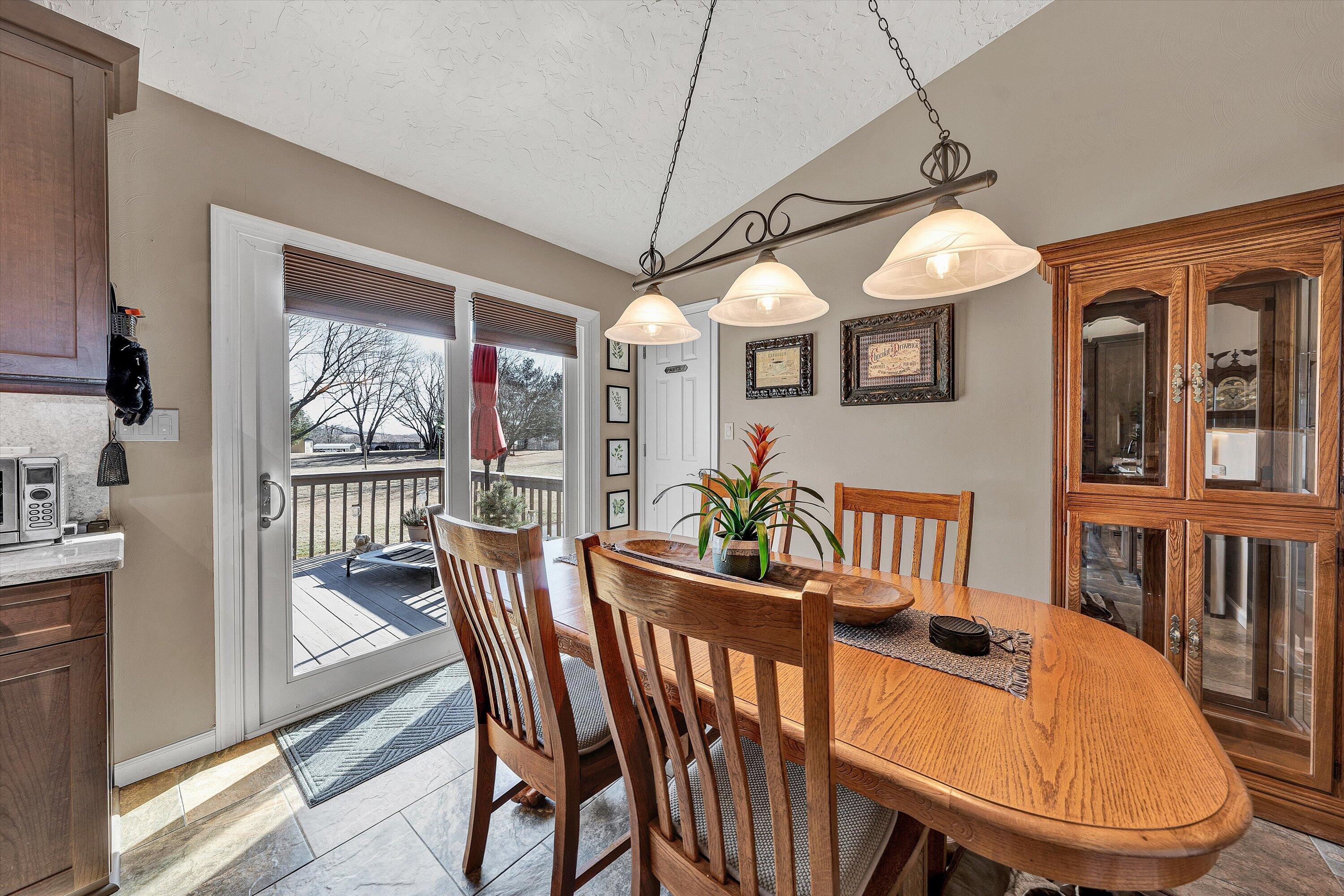 1160 Sandy Level Road Goodview, VA 24095 - Photo 8 of 47 a dining room with furniture a chandelier and wooden floor